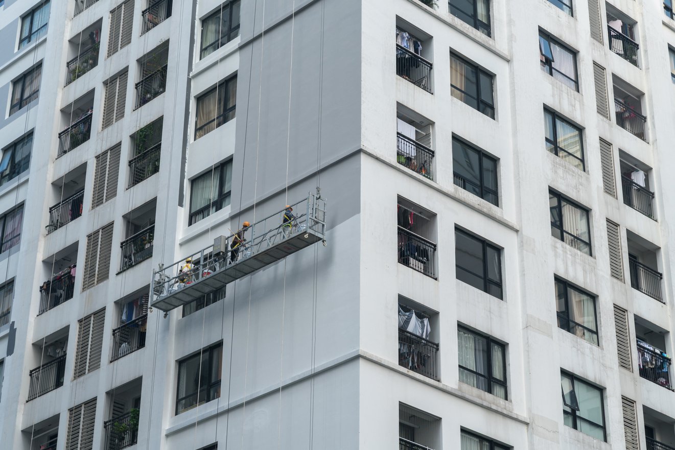 Workers Painting Exterior of High-rise Building